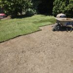 rolling out turf lawn